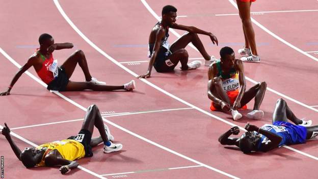 Uganda's Joshua Cheptegei (front L) lies on the track after winning the Men's 10,000m final at the 2019 IAAF Athletics World Championships at the Khalifa International stadium in Doha on October 6, 2019.