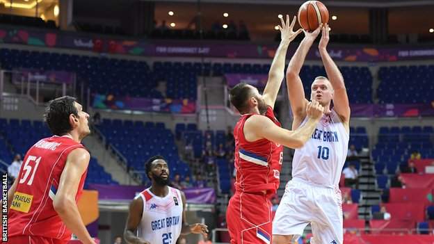 Dan Clark (right) shoots against Russia