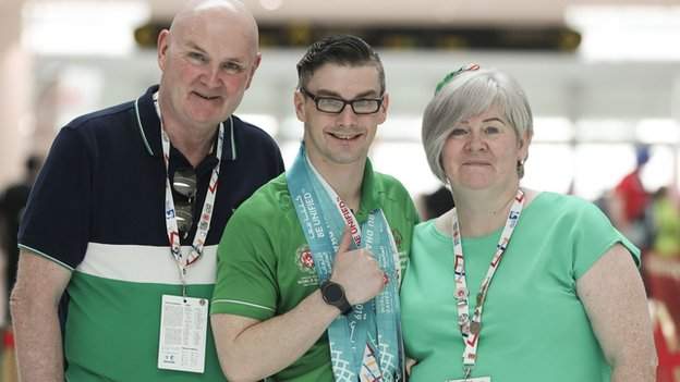 Patrick Quinlivan with his parents after winning a remarkable seven medals on Sunday