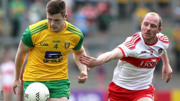 Donegal defender Eoghan Ban Gallagher gets a tug from Derry's Sean Leo McGoldrick at Celtic Park
