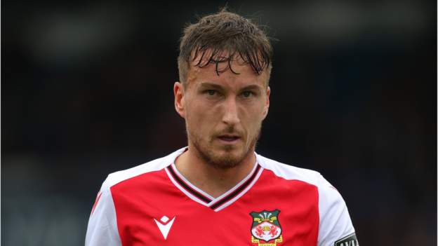 Luke Young: Wrexham captain has contract extended 12 months - BBC Sport