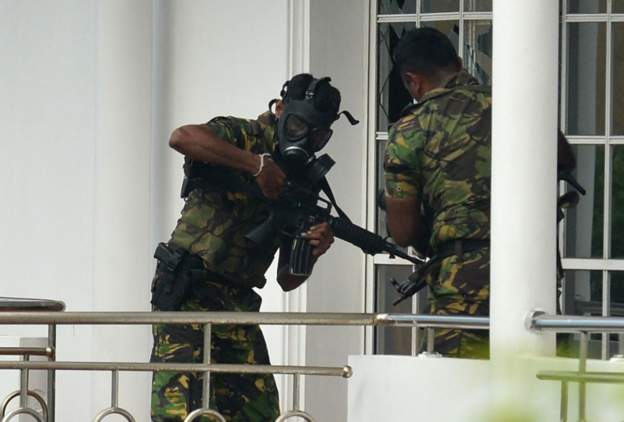 A member of the Sri Lankan Special Task Force (STF) pictured outside a house during a raid.