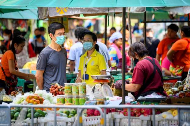 People shop at an open-air market which was reopened in Bangkok. 3 May 2020
