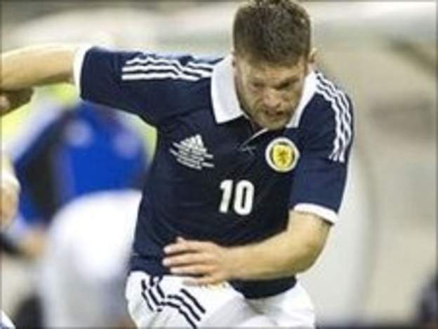 Jamie Mackie battles for possession