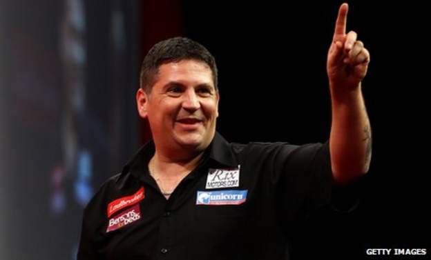 Gary Anderson salutes the crowd at Alexandra Palace