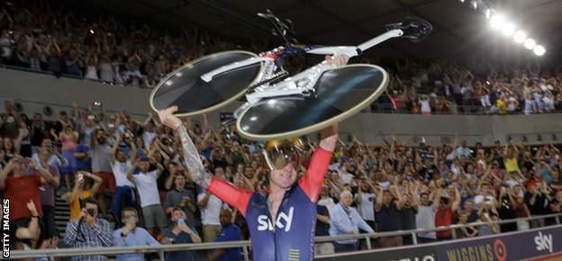 Sir Bradley Wiggins holds his bike aloft after breaking the record