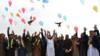 Молодежь выпускает воздушные шары и голубей во время празднования снижения уровня насилия в Джалал-Абаде 28 февраля