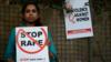 Социальный активист держит плакаты во время акции протеста против изнасилований в деревне Хауз Хас в Дели 21 февраля 2017 года