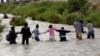 Мигранты из Центральной Америки образуют живую цепочку, чтобы пересечь реку Рио-Браво, чтобы нелегально въехать в Соединенные Штаты и сдаться с просьбой о предоставлении убежища в Эль-Пасо, штат Техас, США, как видно из Сьюдад-Хуарес, Мексика 11 июня 2019 г. || |