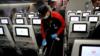 Сотрудник Japan Airlines в защитной маске и перчатках чистит салон самолета после выполнения внутреннего рейса