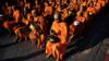 Буддийские монахи собираются на массовую молитву через неделю после того, как одинокий солдат застрелил 29 человек в Таиланде