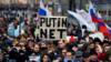 Протестующий держит плакат с надписью "Путин - нет!" во время митинга оппозиции в центре Москвы 10 марта