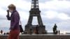 Люди носят маски рядом с Эйфелевой башней в Париже, Франция, 23 сентября 2020 г.