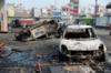 Местные жители смотрят на сгоревших автомобилей после столкновения между людьми и против спорное поправки к Индии "s закон о гражданстве, в Нью-Дели 26 февраля 2020