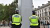 Офицеры полиции стоят у статуи Черчилля на Парламентской площади