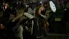 Протестующие держат самодельные щиты во время беспорядков в Кеноше