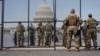 Солдаты Национальной гвардии несут надзор за Капитолием США после того, как Палата представителей отозвала импичмент президенту США Дональду Трампу в Вашингтоне,