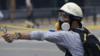 Протестующий стреляет из пращи во время жестокого столкновения в Венесуэле