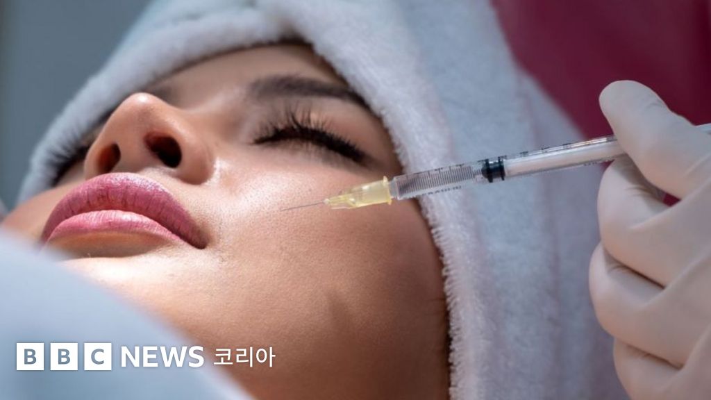 Close up of woman's face being injected with filler