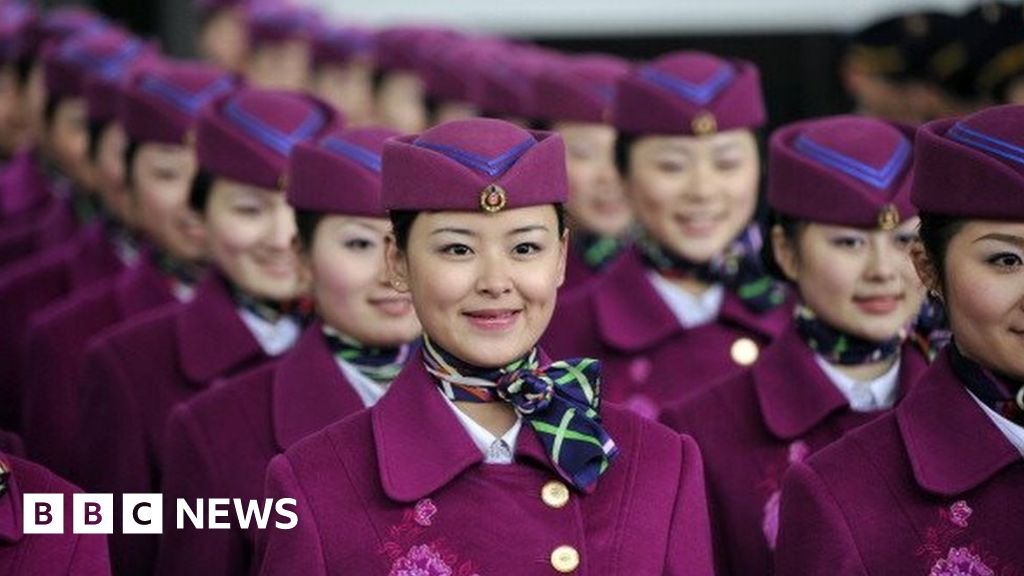 A group of attendants prepare to board a newly-launched bullet train bound for Beijing