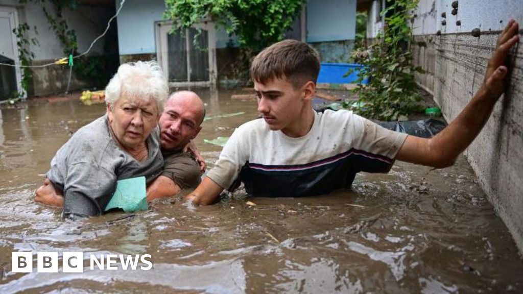 Rush to shore up flood defences amid deaths and evacuations