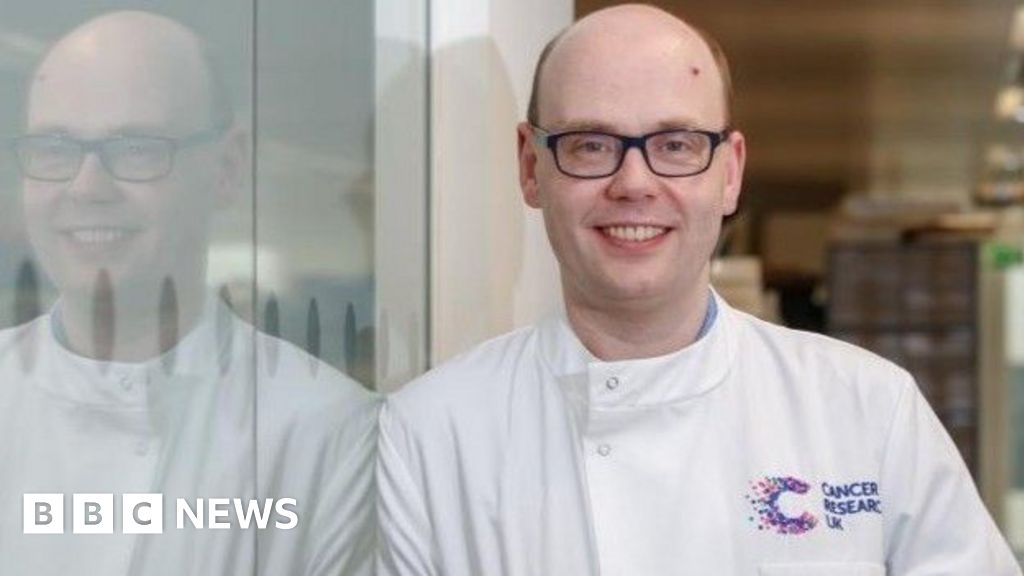 Scientists in a Glasgow laboratory working with cancer research equipment