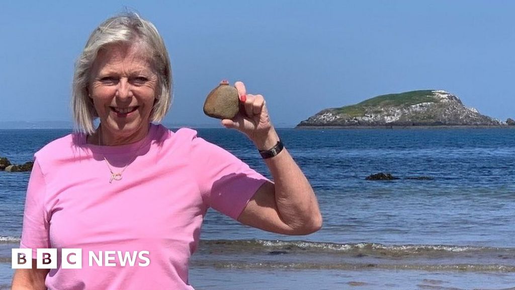 Swimmers brave dangerous tides to collect rock from Uri Geller island