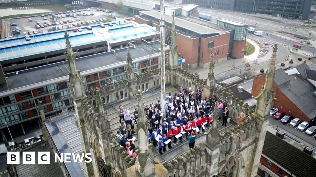 School choir sings on top of church tower