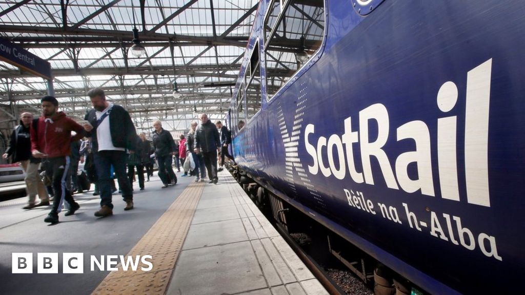A ScotRail train is pictured in a station as commuters disembark