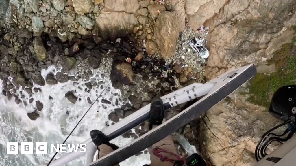 Man arrested after car plunges off California cliff