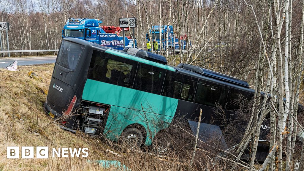 Two in hospital after bus crashes down embankment on A9