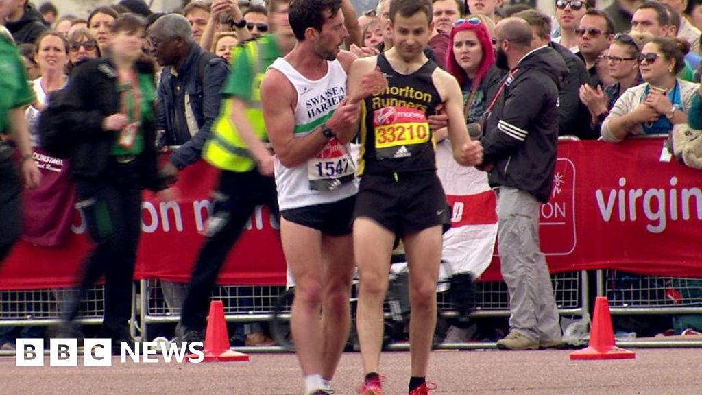 Exhausted London Marathon runner helped across the line BBC News