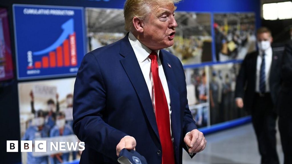 Trump removes mask before facing cameras at car factory thumbnail