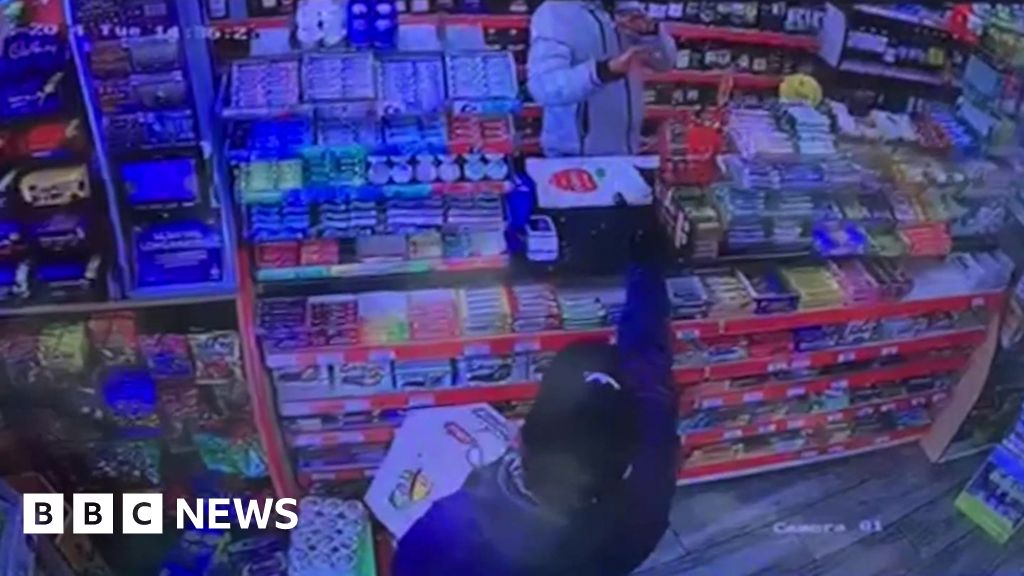 A Grimsby shopkeeper tackled an armed robber who stole beer from his store