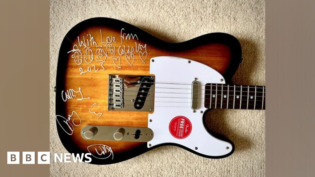 Signed Coldplay guitar raises £3,500 for two schools near Frome
