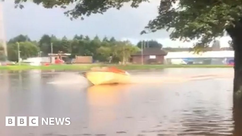 Speedboat races across flooded rugby pitch in Kilmarnock - BBC News