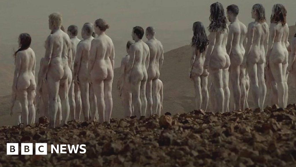Hundreds of people strip naked by the Dead Sea