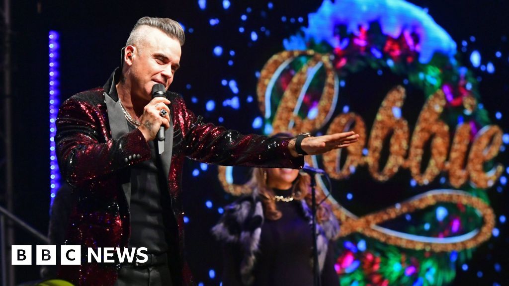 Robbie Williams hits number one and equals Elvis Presley's UK chart