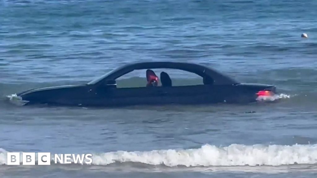 Car in sea at Trevaunance Cove, St Agnes