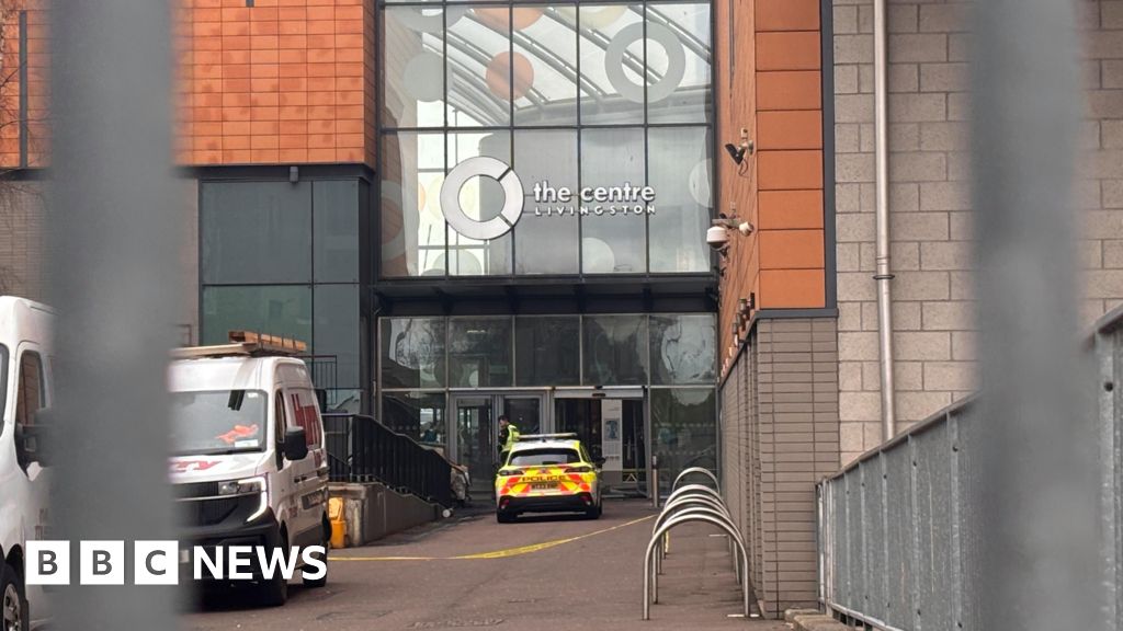 Car set alight in shopping centre after designer clothes ram raid