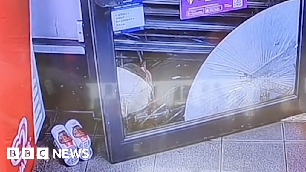 Trapped robber drinks lager under shop shutters