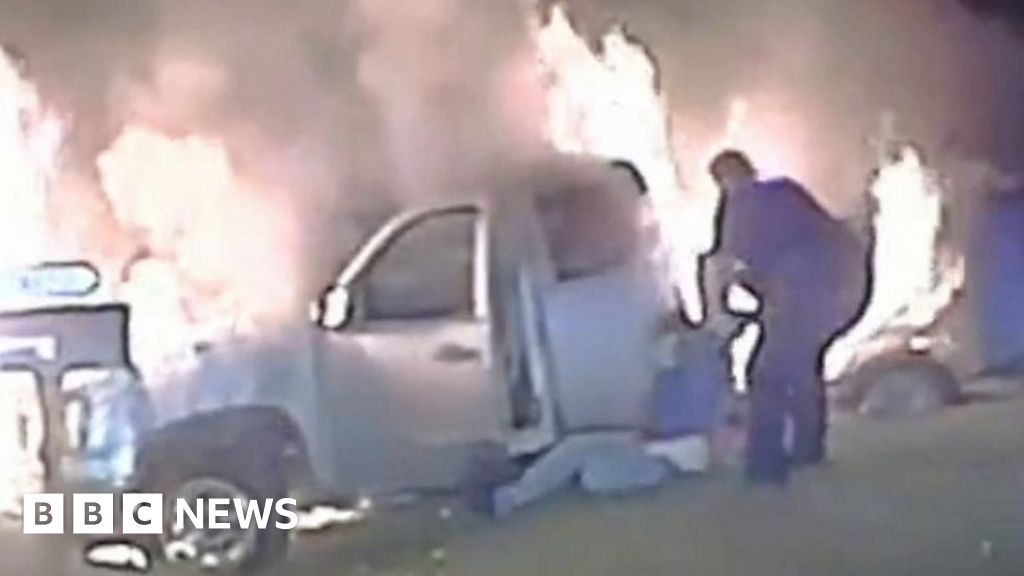 Watch: Police officer drags woman to safety from burning car