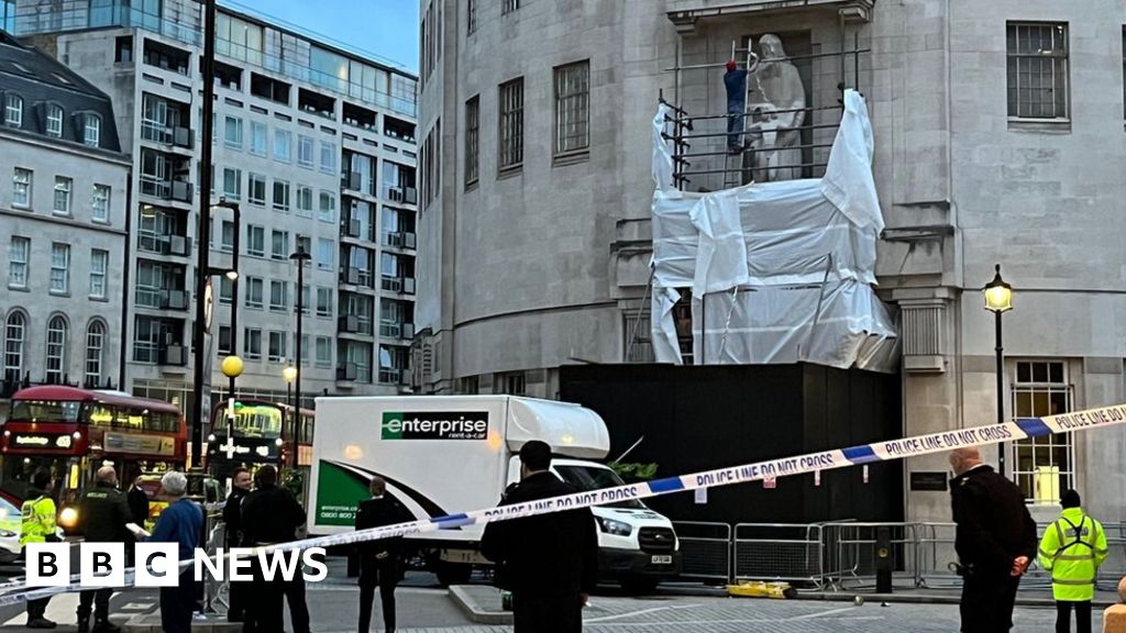 Man scales BBC HQ and hits statue with hammer