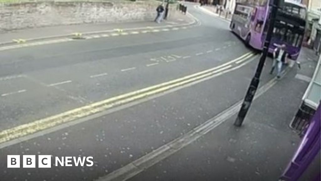 Man hit by bus while walking on street