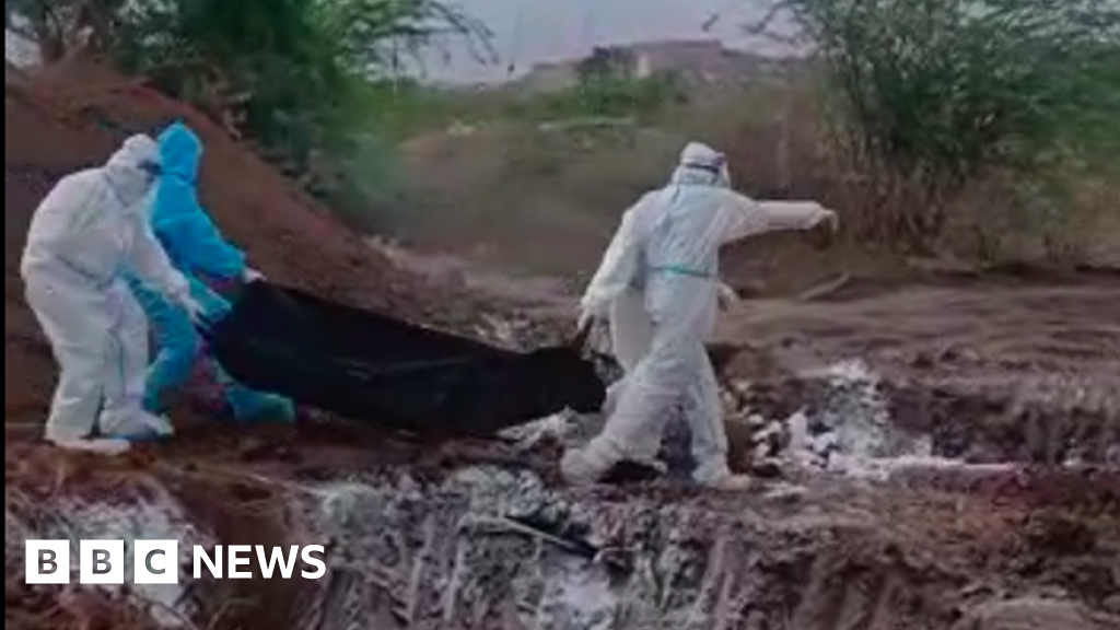 India coronavirus: Officials sorry after video shows bodies flung into pit