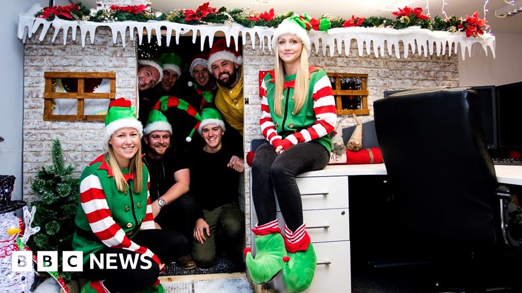 Office workers transform boss's desk into Santa's grotto BBC News