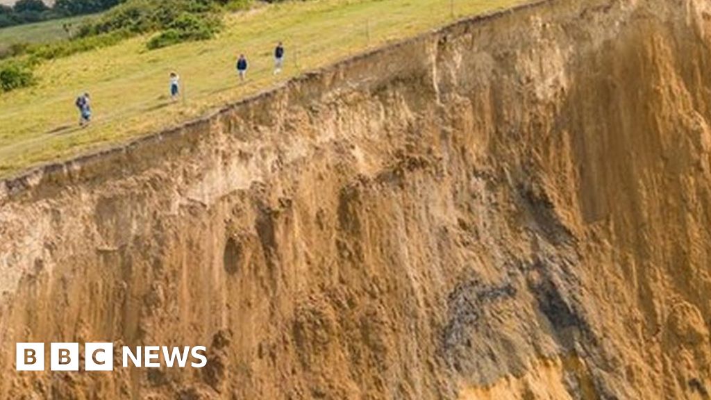 Drone footage captures people above Dorset cliff collapse despite warnings - BBC News