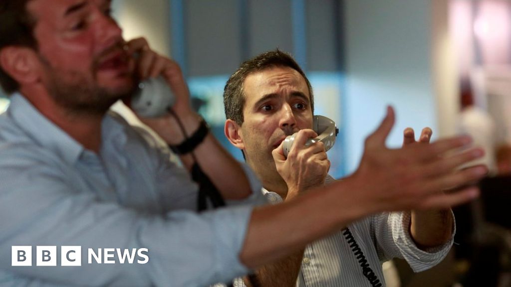 Traders from BGC, a global brokerage company in London’s Canary Wharf financial centre, react as European stock markets open on 24 June 2016