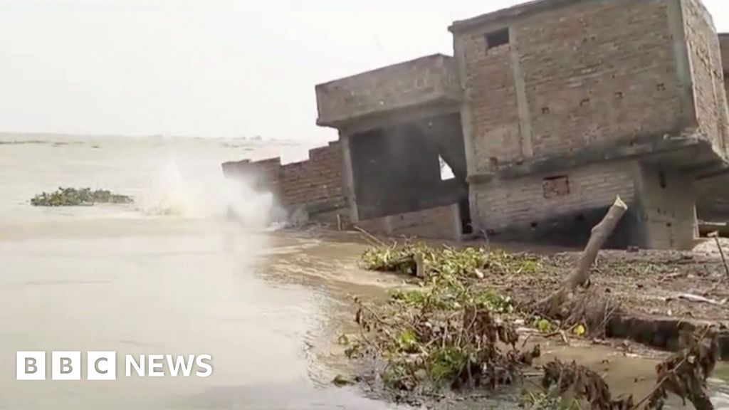 Watch: Building collapses into river in India