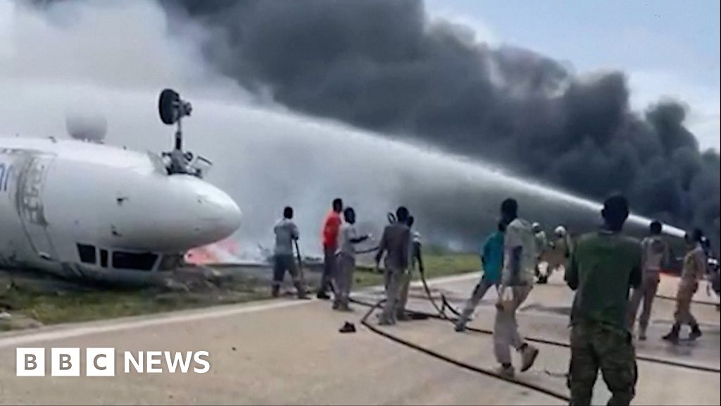 Firefighters tackle blaze by flipped-over plane